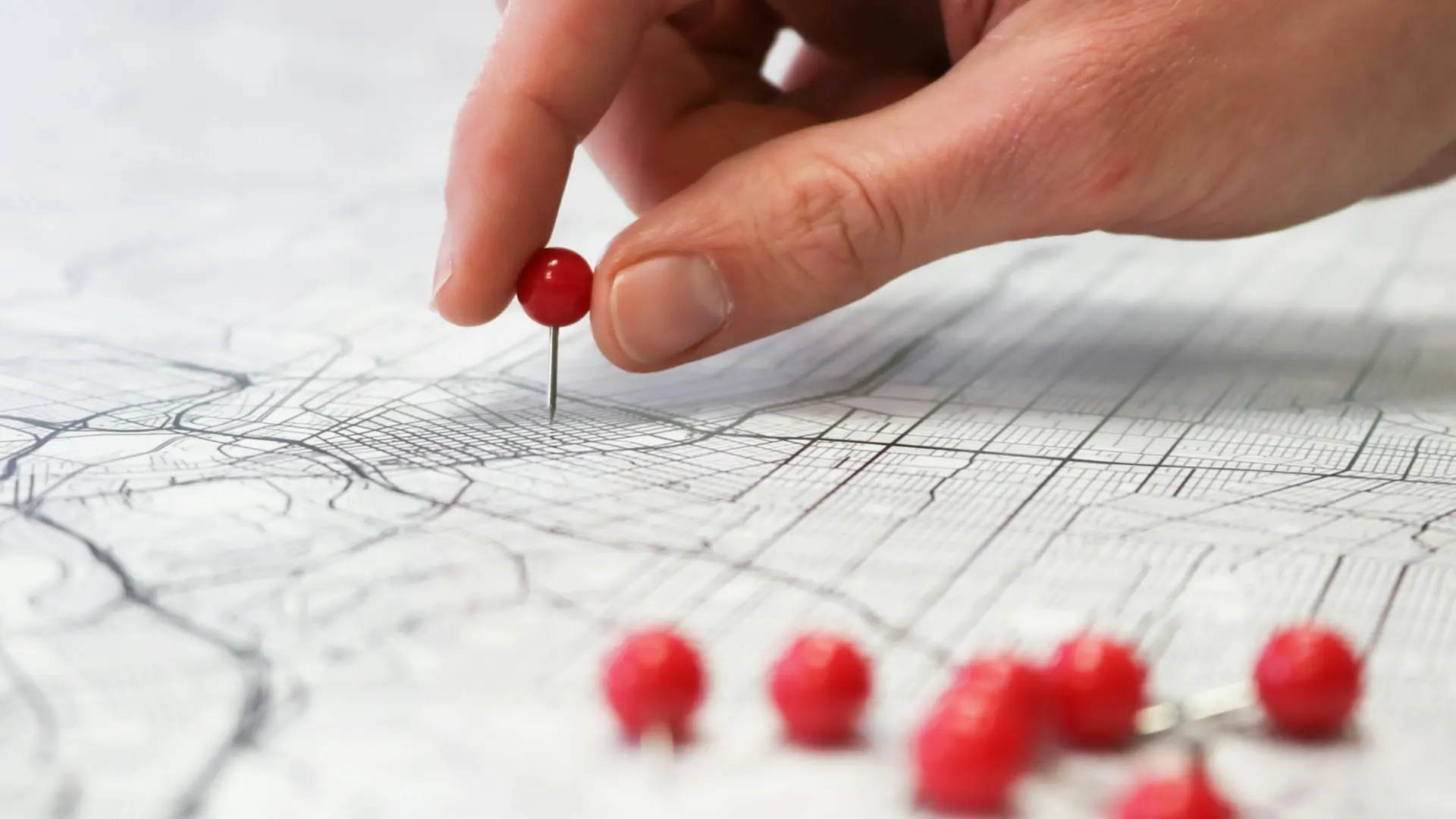 red push pins in a city map