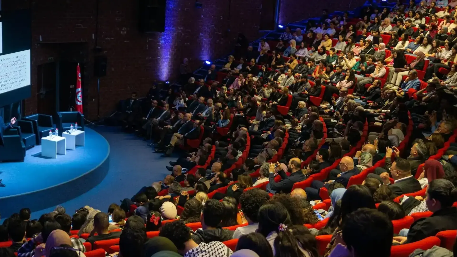 a speaker giving a presentation to a large audience